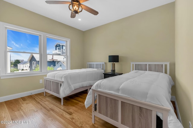 bedroom with recessed lighting, ceiling fan, baseboards, and light wood-type flooring