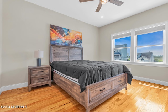 bedroom with recessed lighting, light wood-style floors, a ceiling fan, and baseboards
