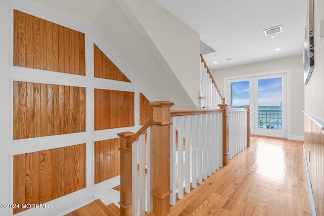 hall with wood finished floors and visible vents