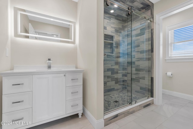 bathroom featuring vanity, baseboards, and a shower stall