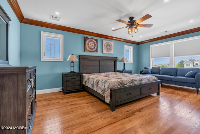 bedroom with multiple windows, visible vents, and crown molding