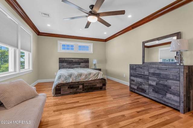 bedroom featuring baseboards, visible vents, wood finished floors, ceiling fan, and ornamental molding