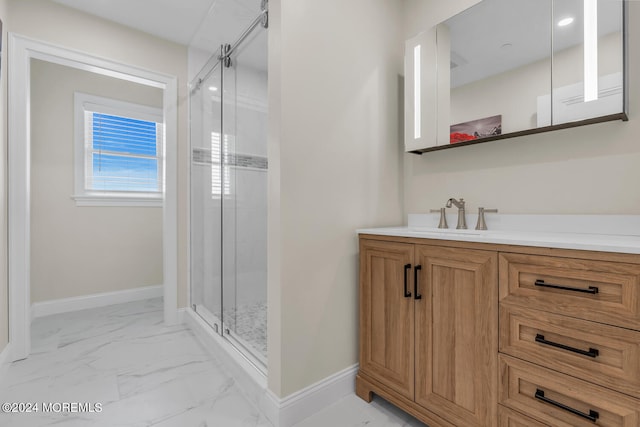 bathroom featuring baseboards, vanity, marble finish floor, and a shower stall