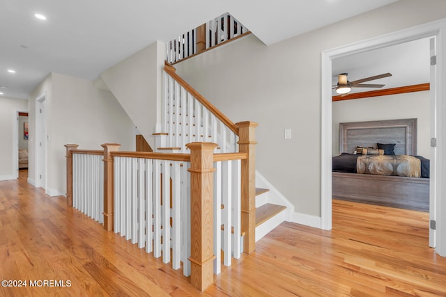 stairway with baseboards, a ceiling fan, wood finished floors, and recessed lighting