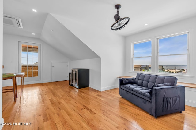 living room with recessed lighting, lofted ceiling, visible vents, light wood-style floors, and baseboards