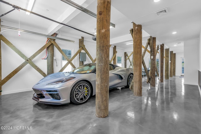 garage featuring baseboards, visible vents, and recessed lighting