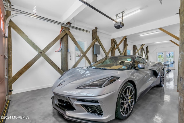 garage with baseboards and a garage door opener