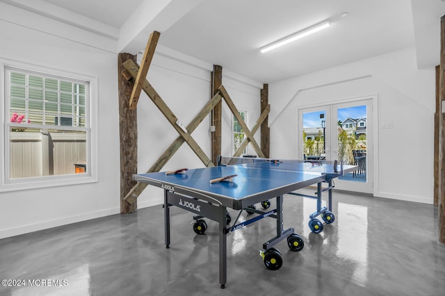 game room with concrete floors, french doors, and baseboards