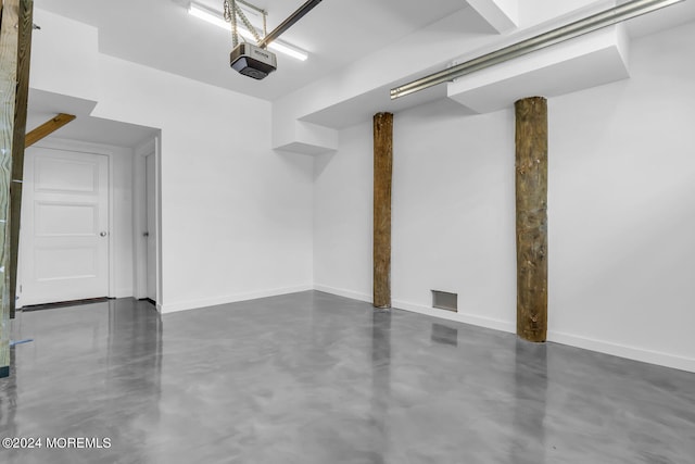 garage featuring baseboards and a garage door opener