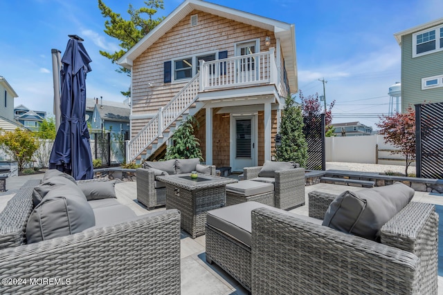 view of patio featuring an outdoor hangout area, a fenced backyard, and stairs