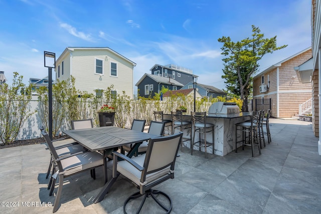 view of patio with a fenced backyard, outdoor dry bar, and a residential view