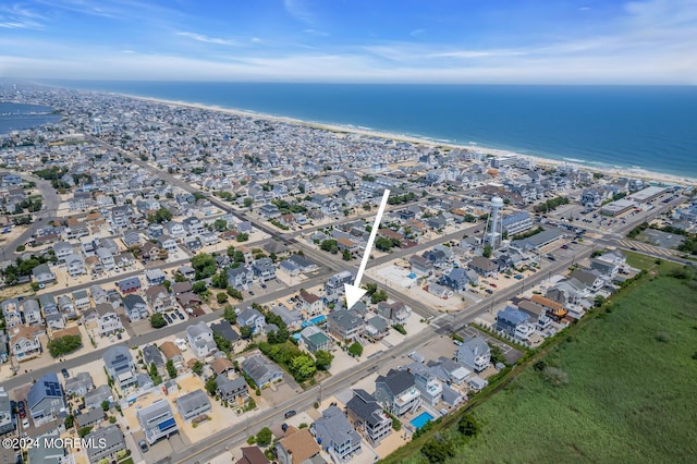 drone / aerial view with a beach view and a water view