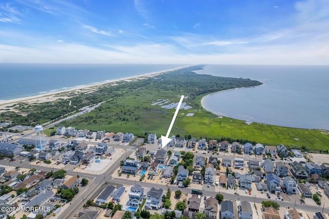 aerial view with a beach view, a residential view, and a water view
