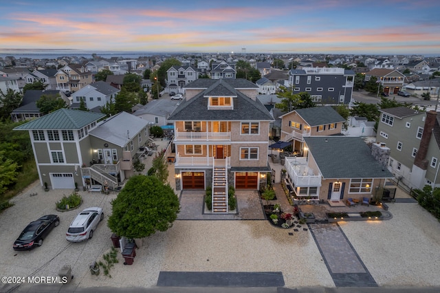 aerial view at dusk featuring a residential view