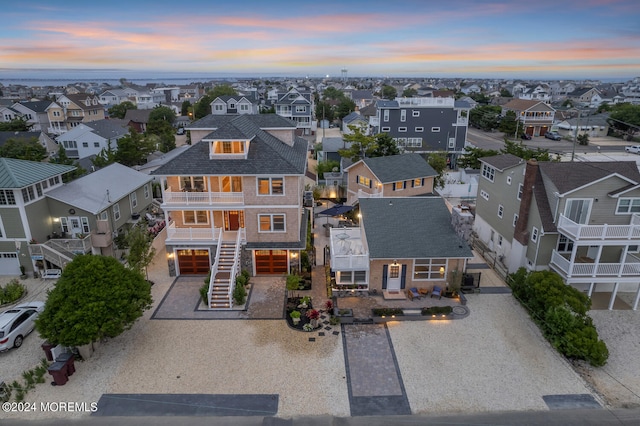 aerial view at dusk featuring a residential view