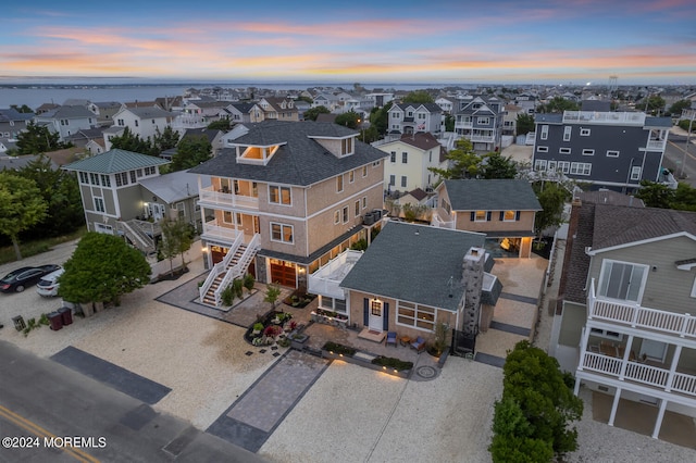 aerial view at dusk featuring a residential view