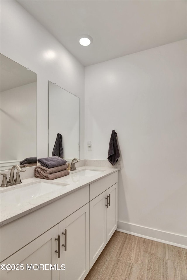 105 Pilot St, Marlboro, NJ 07746 - full bath featuring baseboards, wood finished floors, a sink, and double vanity