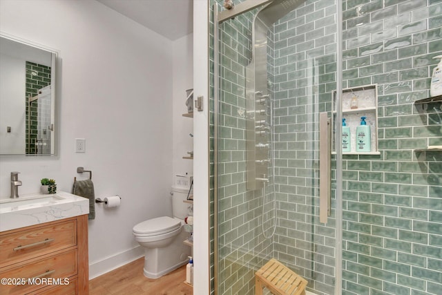 105 Pilot St, Marlboro, NJ 07746 - full bathroom featuring toilet, wood finished floors, vanity, baseboards, and tiled shower