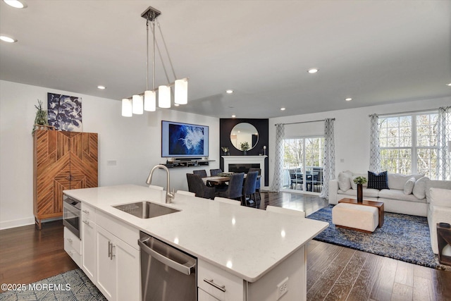 105 Pilot St, Marlboro, NJ 07746 - kitchen with dark wood finished floors, stainless steel dishwasher, open floor plan, and a sink