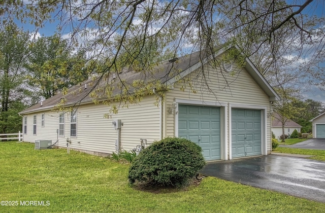 34 Meadows Ln, Manchester, NJ 08759 - view of property exterior featuring a yard, fence, aphalt driveway, a garage, and cooling unit