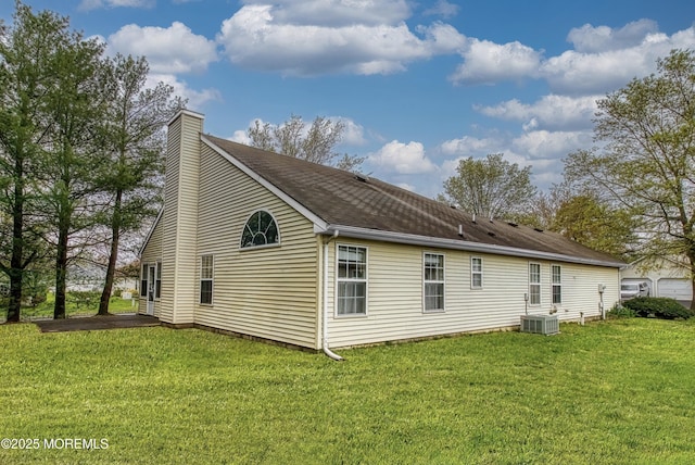 34 Meadows Ln, Manchester, NJ 08759 - rear view of house featuring a lawn, a chimney, cooling unit, and a shingled roof