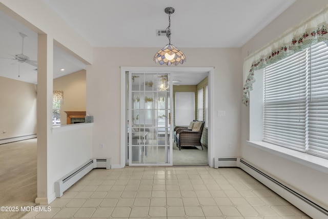 34 Meadows Ln, Manchester, NJ 08759 - unfurnished dining area with a ceiling fan, baseboard heating, and a healthy amount of sunlight