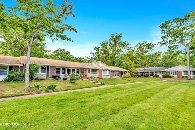 627 Huntington Dr Unit C, Lakewood, NJ 08701 - ranch-style home featuring brick siding and a front lawn