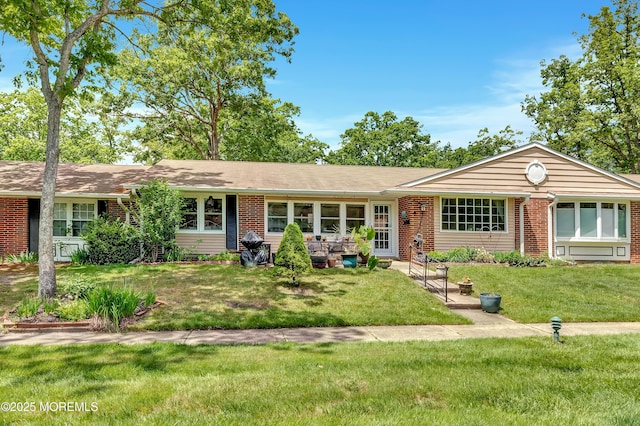 627 Huntington Dr Unit C, Lakewood, NJ 08701 - ranch-style house with a front lawn and brick siding