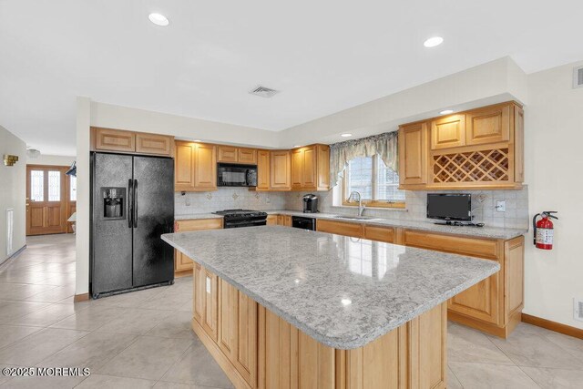 42 Circle Ct, Brick, NJ 08723 - kitchen featuring visible vents, a sink, light stone countertops, a center island, and black appliances