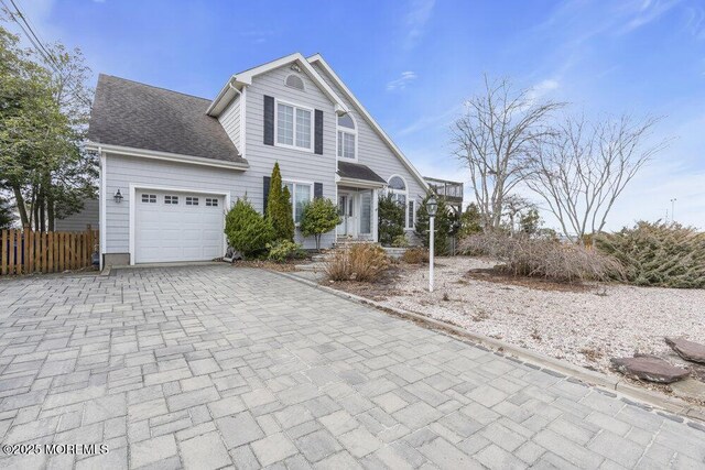 42 Circle Ct, Brick, NJ 08723 - view of front facade featuring a garage, a shingled roof, decorative driveway, and fence