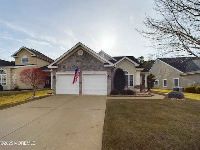 89 Pebble Beach Blvd, Jackson, NJ 08527 - view of front of house featuring stone siding, concrete driveway, an attached garage, and a front lawn