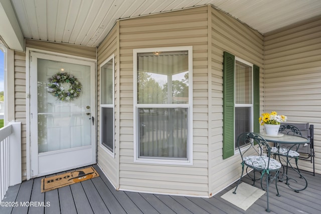 view of exterior entry featuring outdoor dining area
