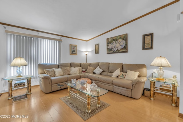 living area with crown molding and light wood-style flooring
