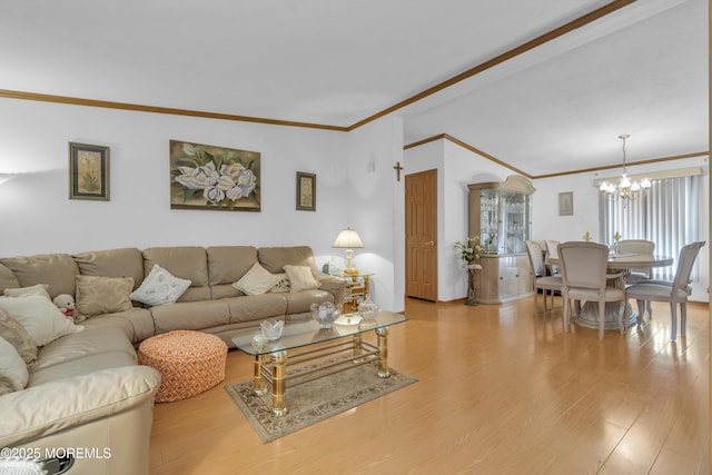 living room featuring an inviting chandelier, crown molding, vaulted ceiling, and light wood-style flooring