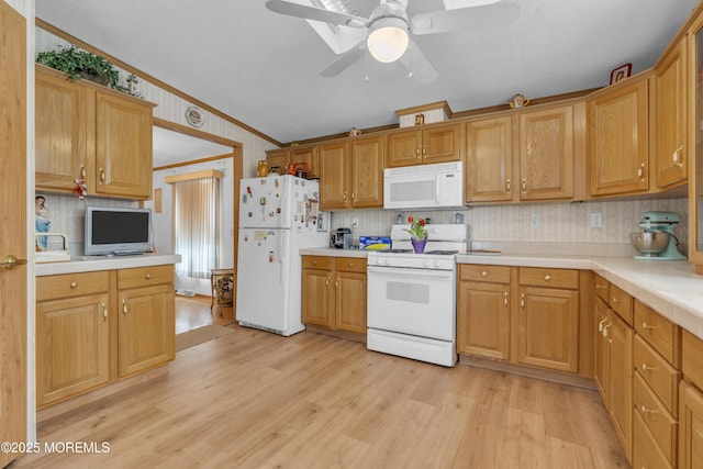 kitchen featuring light countertops, light wood-type flooring, ceiling fan, and white appliances