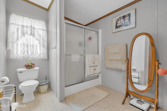 full bathroom featuring toilet, crown molding, tile patterned floors, and a stall shower