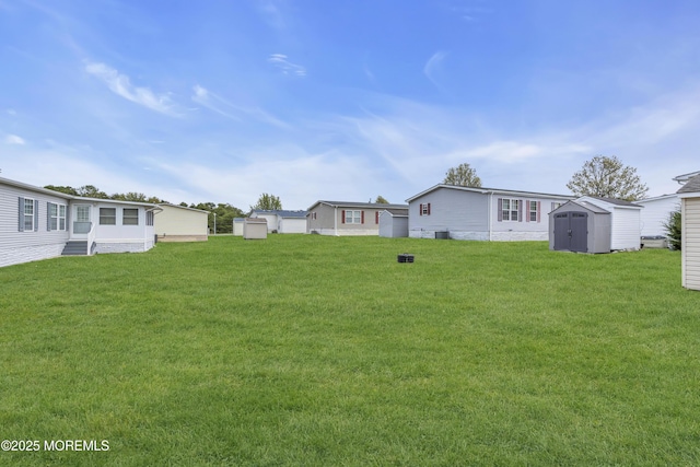 view of yard featuring a storage shed and an outdoor structure