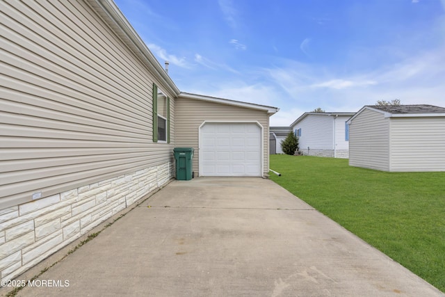 view of side of home with an attached garage, driveway, a yard, and stone siding