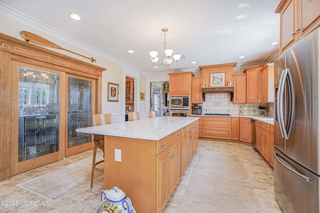 kitchen with crown molding, appliances with stainless steel finishes, a chandelier, recessed lighting, and tasteful backsplash