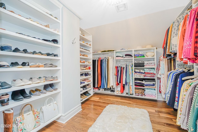 walk in closet with visible vents and wood finished floors