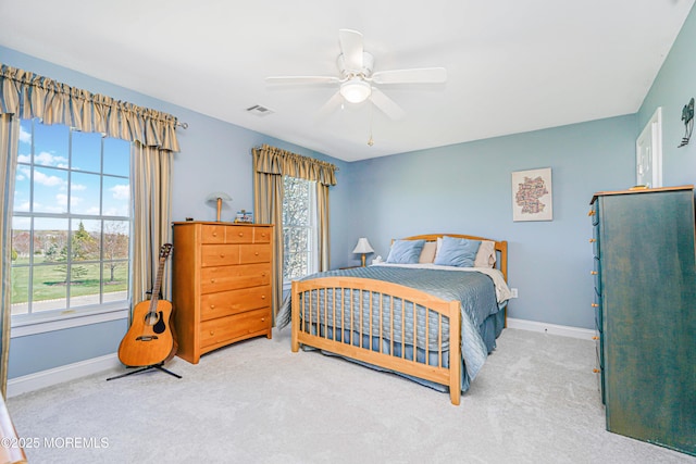 bedroom featuring baseboards, multiple windows, and carpet