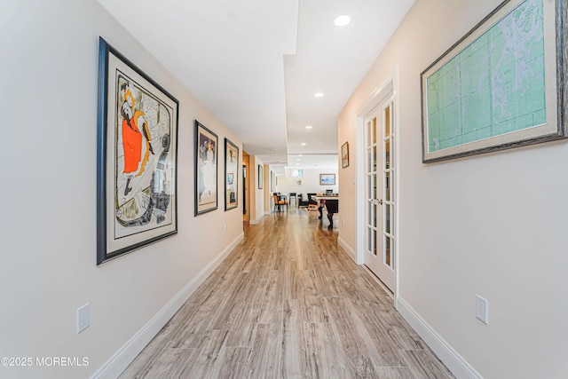 hallway with recessed lighting, baseboards, and light wood-style flooring
