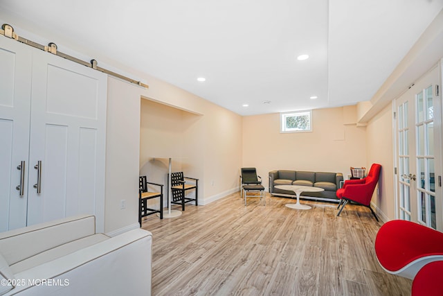 living area with recessed lighting, baseboards, and wood finished floors