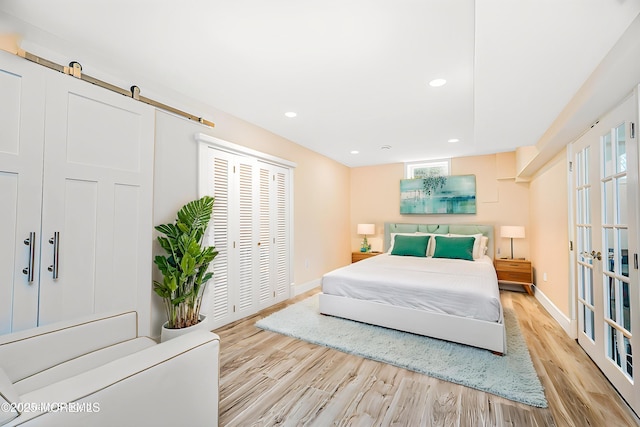 bedroom featuring baseboards, recessed lighting, wood finished floors, and multiple windows