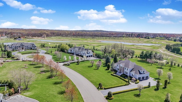 drone / aerial view featuring a water view and golf course view