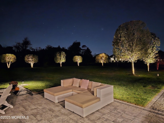 patio at twilight with a yard and an outdoor living space