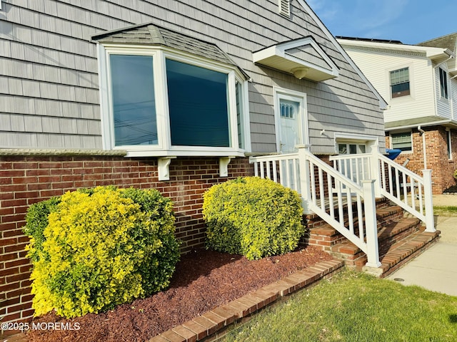 property entrance featuring brick siding