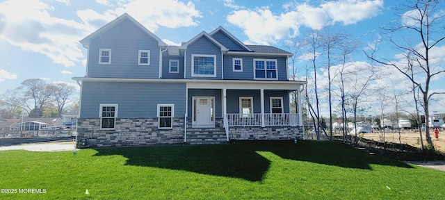 craftsman-style house featuring a porch, a front yard, and stone siding
