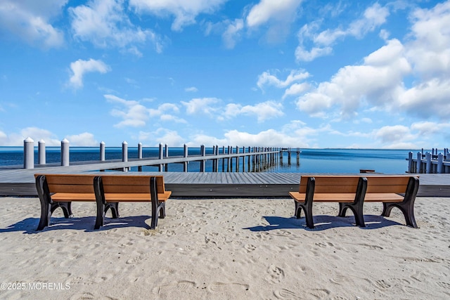 view of home's community featuring a dock and a water view