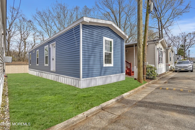 2505 Woodbridge Ave Unit 32Lane M, Edison, NJ 08817 - view of property exterior with fence, a lawn, and aphalt driveway